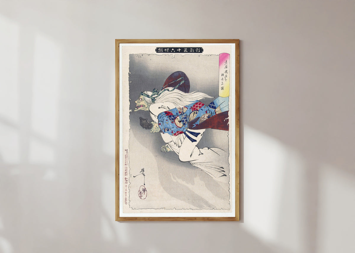 Framed art print of The Witch by Tsukioka Yoshitoshi, in a light wood frame on a sunlit white wall