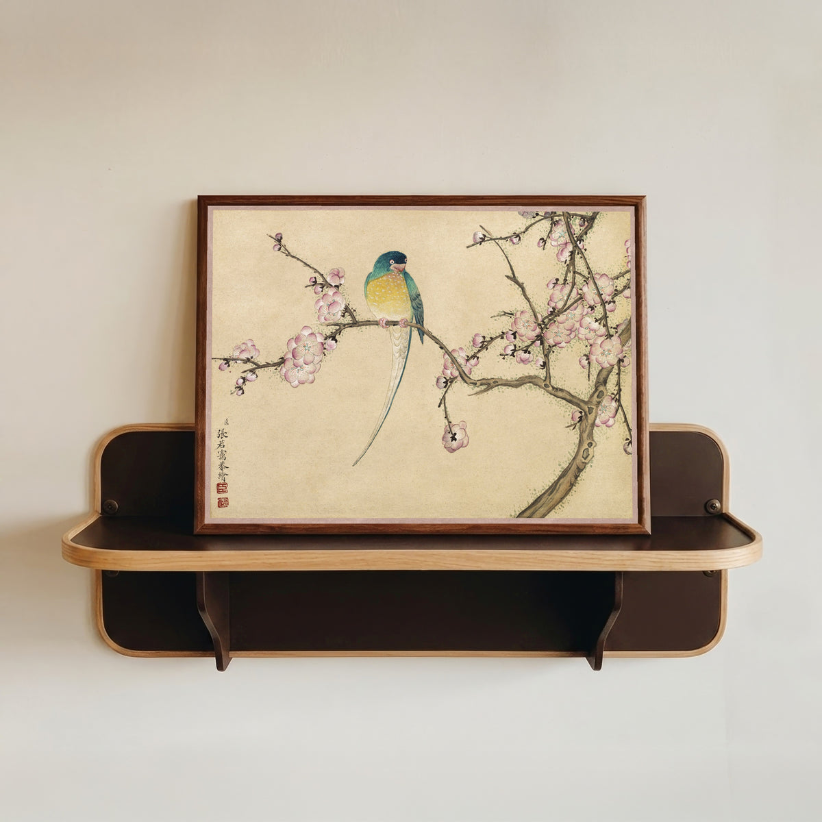 Framed art print of Desk Album: Flower and Bird Paintings (Bird with Plum Blossoms) by Zhang Ruoai, in a dark wood frame resting on a wall shelf