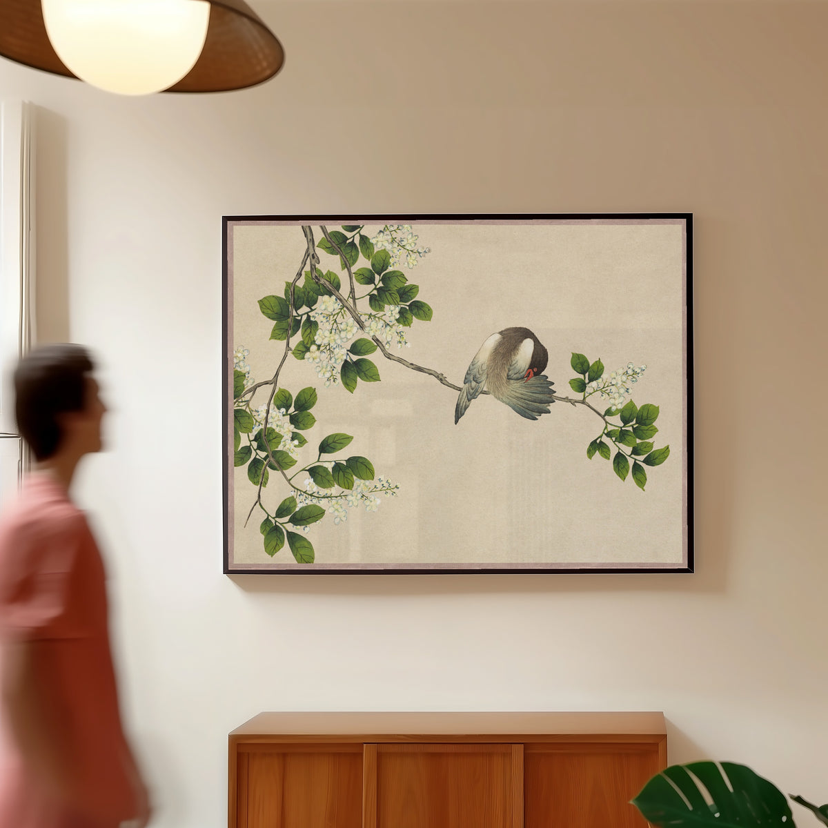 Framed art print of Desk Album: Flower and Bird Paintings (Preening Bird) by Zhang Ruoai, in a slim black frame on a warm wall in a sunlit room